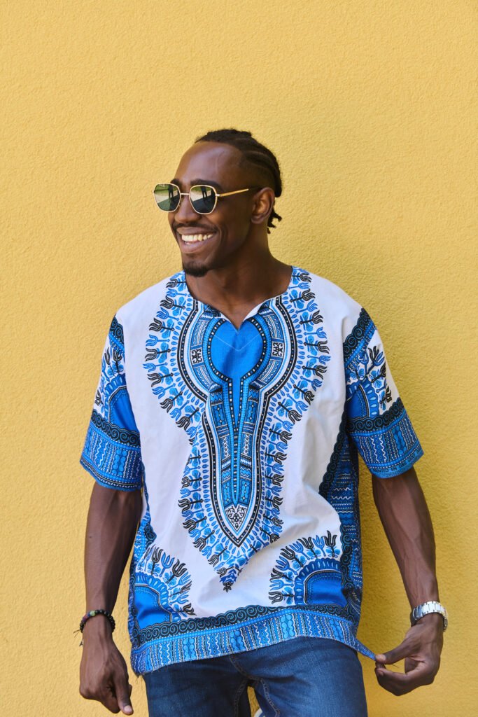 Smiling young African man in traditional attire, representing opportunity for youth