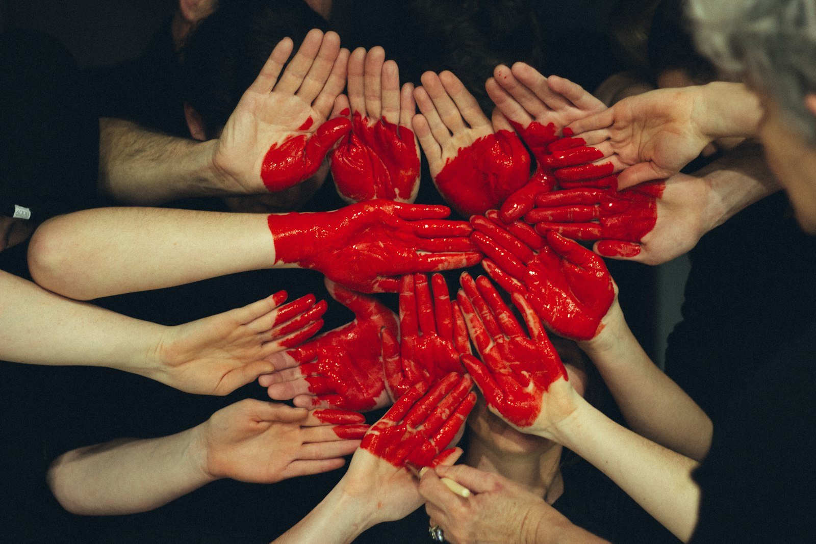 Painted hands forming a heart, people at the center of our vision
