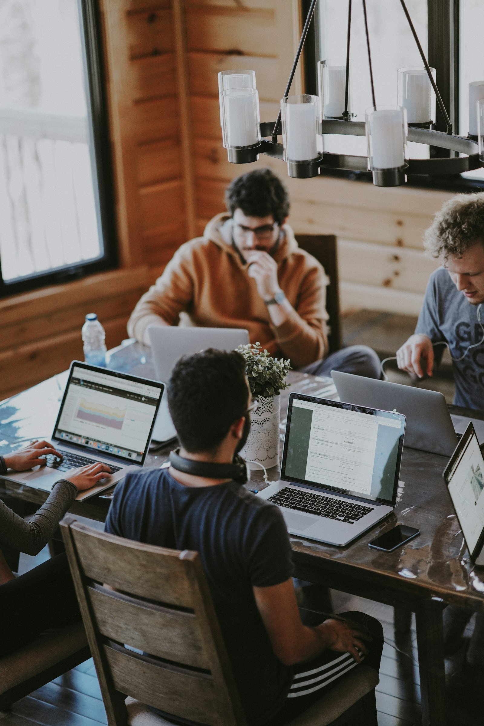 Team of developers collaborating on code at shared desks