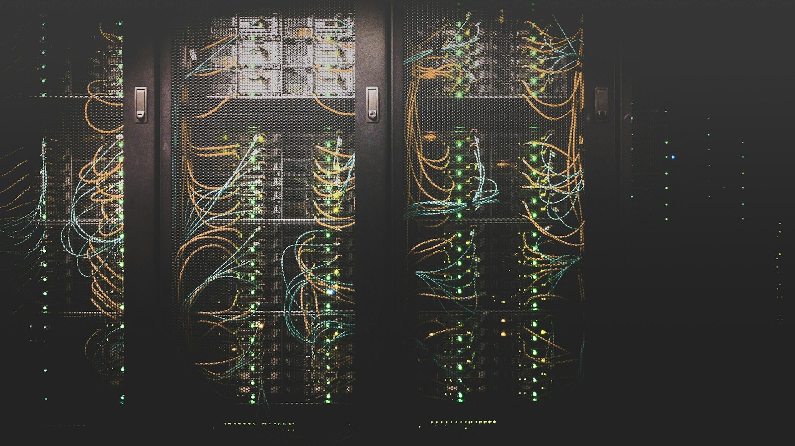 Rows of illuminated server racks in a data center